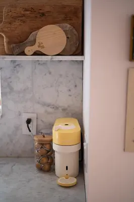 a kitchen with a trash can and a wooden spoon at Sun-Filled Century Home in Hamilton