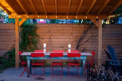 a table with red chairs and candles on top at Sun-Filled Century Home in Hamilton