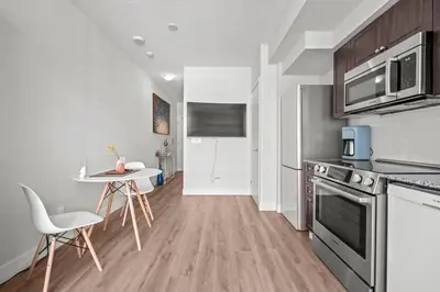 a kitchen with a table and chairs in a room at Charming Studio in Downtown Toronto in Toronto