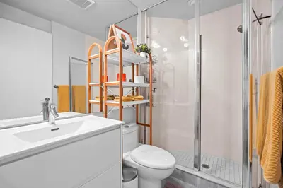 a bathroom with a toilet and a sink and a shower at Charming Studio in Downtown Toronto in Toronto