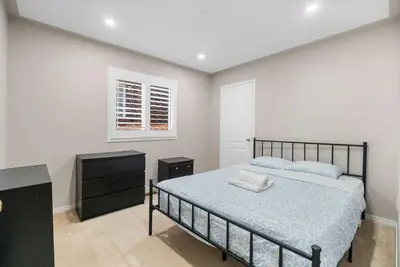 a bedroom with a bed and a dresser and a window at Cozy Family Home Netflix Backyard and Quiet Area in Mississauga