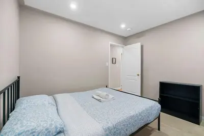 a bedroom with a bed with a towel on it at Cozy Family Home Netflix Backyard and Quiet Area in Mississauga