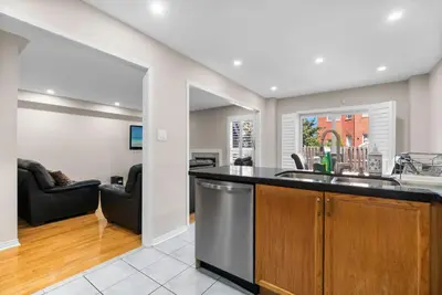 a kitchen and living room with a sink and a counter at Cozy Family Home Netflix Backyard and Quiet Area in Mississauga