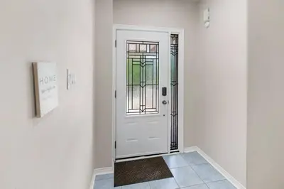 a white door with a window in a hallway at Cozy Family Home Netflix Backyard and Quiet Area in Mississauga