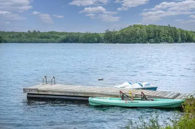 two boats are docked at a dock on a lake at Butterfly Lake House | Cozy & Peaceful Stay in Port Carling