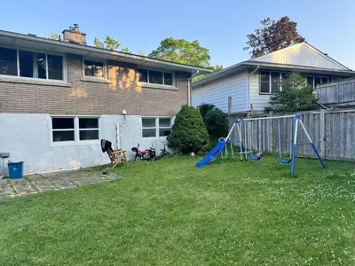 a yard with a playground and a house at Luxe Living Prime Location in Kitchener