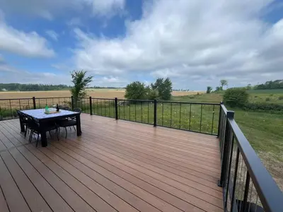 a wooden deck with a table and a fence at Duncan in Kimberley