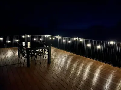 a table and chairs on a deck at night at Duncan in Kimberley