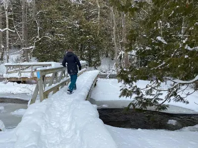 a person walking across a bridge in the snow at Duncan in Kimberley