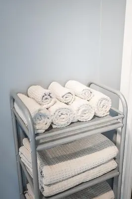 a towel rack with white towels on it at Panoramic Lake View 1 Bedroom plus Den Condo Iceboat Terrace Downtown Toronto in Toronto
