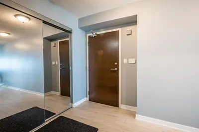 a hallway with a glass door in a room at Panoramic Lake View 1 Bedroom plus Den Condo Iceboat Terrace Downtown Toronto in Toronto