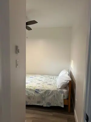 a small bedroom with a bed in the corner at Water Front Cottage - Balsam Lake in Victoria Road