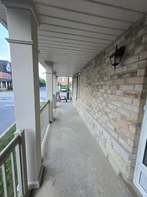 a hallway of a building with a brick wall at One Bed basement Room in Brampton