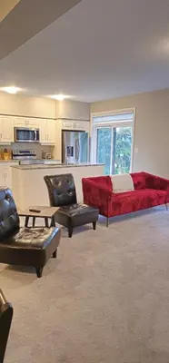 a living room with a red couch and a kitchen at 3BR Townhome Wright Dr Midland Near Little Lake in Midland
