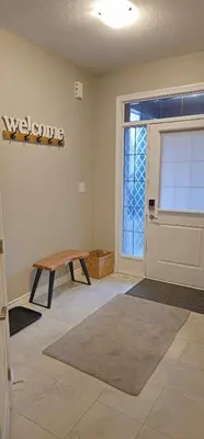a living room with a table and a door at 3BR Townhome Wright Dr Midland Near Little Lake in Midland