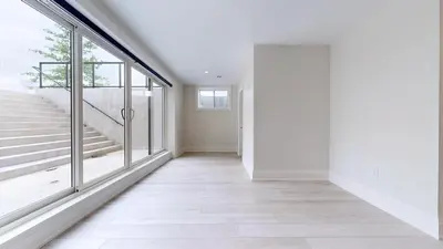 a hallway with a large window and a staircase at Lucky Mansion - a Luxury Villa in Fort Erie ! in Fort Erie