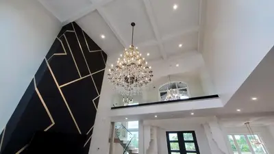 a chandelier hanging from the ceiling of a room at Lucky Mansion - a Luxury Villa in Fort Erie ! in Fort Erie
