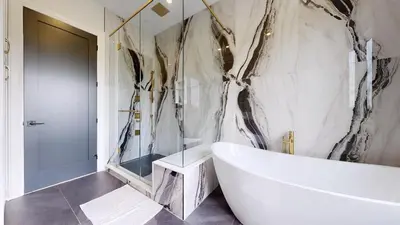 a bathroom with a white tub and a sink at Lucky Mansion - a Luxury Villa in Fort Erie ! in Fort Erie
