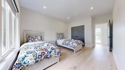 a bedroom with two beds and a large window at Lucky Mansion - a Luxury Villa in Fort Erie ! in Fort Erie