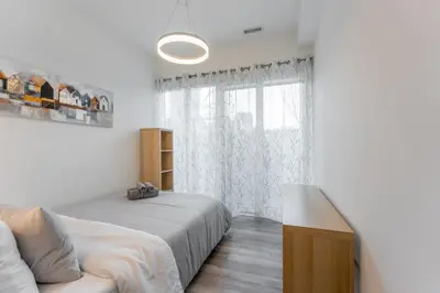 a bedroom with two beds and a window at Shore Breeze in Toronto