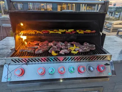 a grill with meat and other food on it at Shore Breeze in Toronto