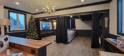 a living room with a christmas tree in a room at Modern Loft with Immersive Theatre Experience in Milton