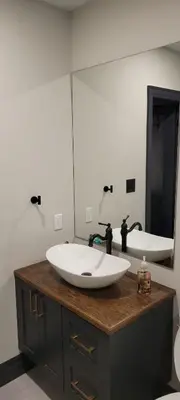 a bathroom with a sink and a large mirror at Modern Loft with Immersive Theatre Experience in Milton