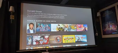 a television screen with a movie projected on it at Modern Loft with Immersive Theatre Experience in Milton