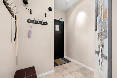 a hallway with a door leading into a room at Downtown Condo with Picturesque View in Toronto