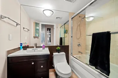 a bathroom with a toilet and a sink and a shower at Downtown Condo with Picturesque View in Toronto