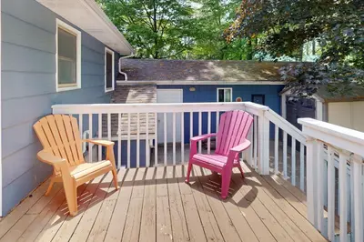 two chairs sitting on a deck in front of a house at Wavy Daze Master in Wasaga Beach