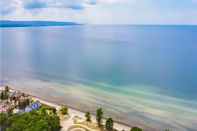an aerial view of a beach and the ocean at Wavy Daze Master in Wasaga Beach