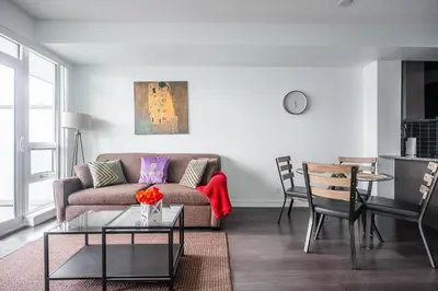 a living room with a couch and a table at Modern 1 Bedroom Dunfield Ave Apartment in Toronto