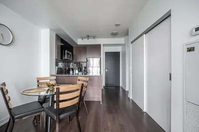 a kitchen and dining room with a table and chairs at Modern 1 Bedroom Dunfield Ave Apartment in Toronto