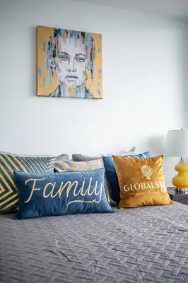 a bed with pillows and a painting on the wall at Modern 1 Bedroom Dunfield Ave Apartment in Toronto