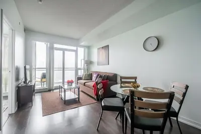a living room with a couch and a table at Modern 1 Bedroom Dunfield Ave Apartment in Toronto