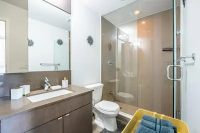 a bathroom with a toilet and a sink and a shower at Modern Apartments 2BR 2BA Lillian St with Balcony in Toronto