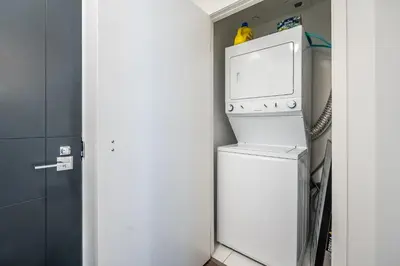 a washer and dryer in a small kitchen with a refrigerator at Modern Apartments 2BR 2BA Lillian St with Balcony in Toronto