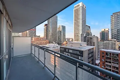 a balcony with a view of a city skyline at Modern 1Bd & Den Condo with Balcony Lillian St in Toronto
