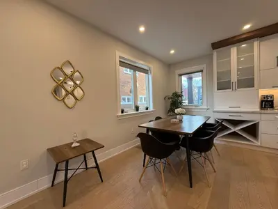 a kitchen with a dining room table and chairs at Prestige 3BR Luxury Living in Queen West in Toronto