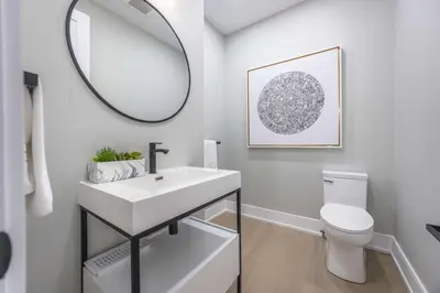 a bathroom with a white sink and a mirror at Prestige 3BR Luxury Living in Queen West in Toronto
