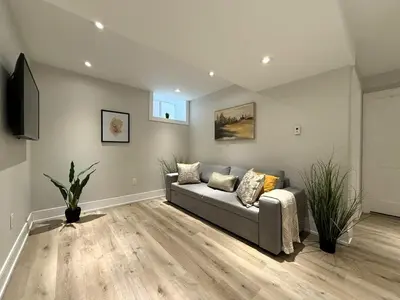 a living room with a couch and a television at Stylish 1BR in Queen West in Toronto