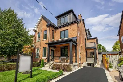 a brick house with a sign in front of it at Stylish 1BR in Queen West in Toronto