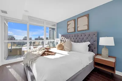 a bedroom with a large white bed and a window at Spacious Retreat Luxe 3BR Condo with City Views in Toronto