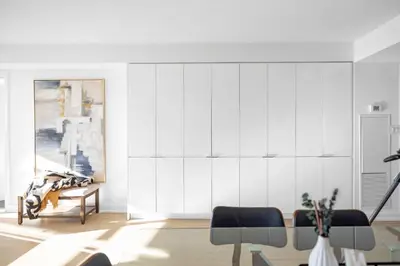 a living room with white walls and a table and chairs at Spacious Retreat Luxe 3BR Condo with City Views in Toronto