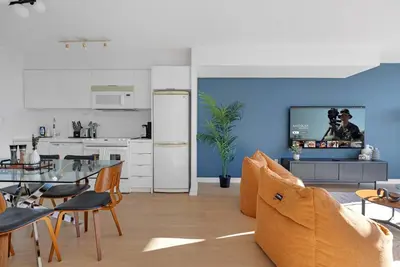 a kitchen and living room with a table and a refrigerator at Spacious Retreat Luxe 3BR Condo with City Views in Toronto