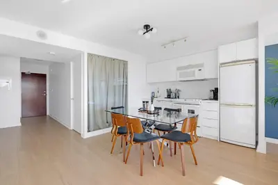 a kitchen and dining room with a table and chairs at Spacious Retreat Luxe 3BR Condo with City Views in Toronto