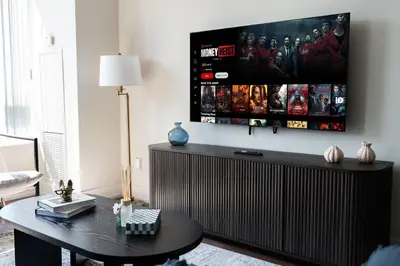 a living room with a table and a tv at Modern 2BR in TO Near Yorkville & the Village in Toronto