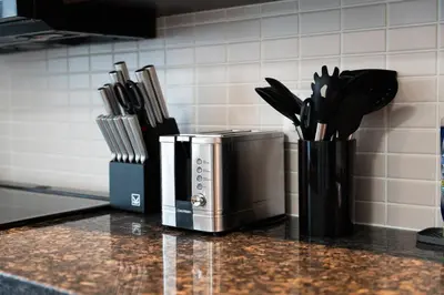 a kitchen counter with a container of kitchen utensils at Modern 2BR in TO Near Yorkville & the Village in Toronto