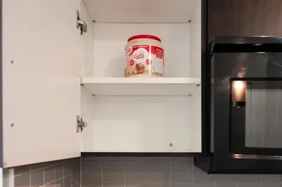 a can of peanut butter sitting on a shelf in a kitchen at Modern 2BR in TO Near Yorkville & the Village in Toronto